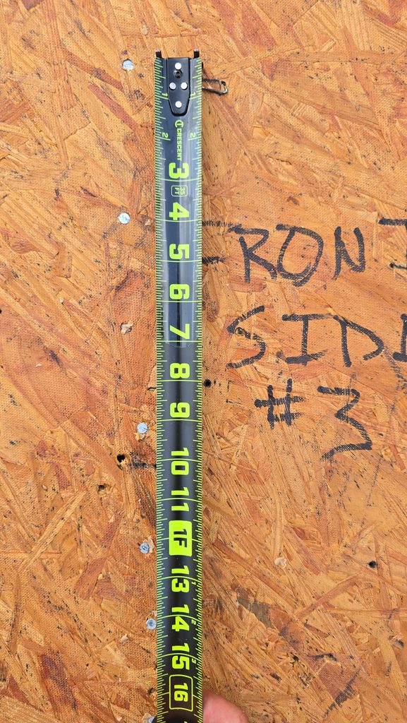 Tape measure showing new ring-shank nails at 4 inches on center on the roof deck