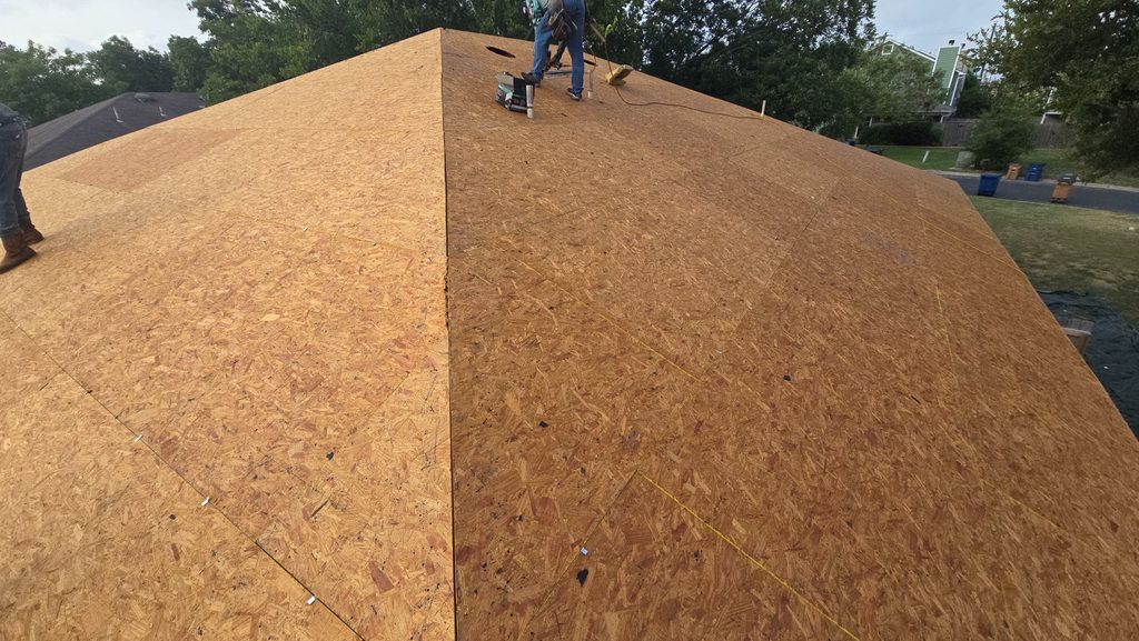 Roofers re-nailing the roof deck during a FORTIFIED roof replacement in Northwest Austin 78729