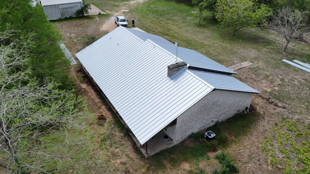 Aerial view of the finished 34-square standing seam roof in Bastrop, TX