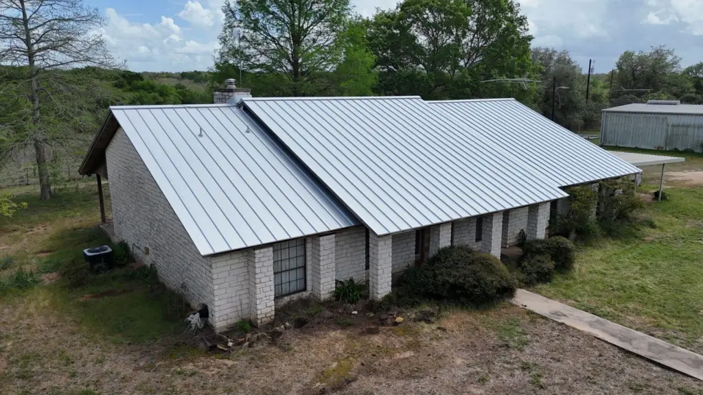 Finished standing seam roof seen from the front corner of the house